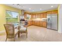 Kitchen with wooden cabinets, stainless steel appliances, and a view of the backyard at 1730 Birmingham Ave, Daytona Beach, FL 32117