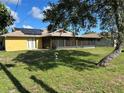 Spacious backyard with screened-in patio and solar panels on the roof at 1887 Viking Ave, Deltona, FL 32725