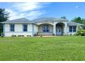 Inviting single-story home with a well-manicured lawn, decorative touches, and a welcoming double-door entrance at 19320 Oberly Pkwy, Orlando, FL 32833