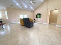 Spacious living room with high ceilings, tile flooring, comfortable seating, and a mounted TV at 19320 Oberly Pkwy, Orlando, FL 32833