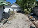 Gravel area for parking in backyard with AC unit, adjacent to a utility garage/shed structure at 1973 S Old Mill Dr, Deltona, FL 32725