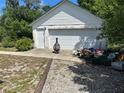 Utility Garage/Shed in backyard next to gravel area, with garage door and storage, good for a workshop at 1973 S Old Mill Dr, Deltona, FL 32725