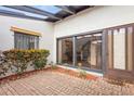 Charming courtyard featuring brick flooring, lush foliage, and a glass-paneled front door at 2080 Roseway Ave, Deltona, FL 32738