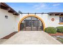 Enclosed courtyard with wrought iron gated entry and desert landscaping at 2080 Roseway Ave, Deltona, FL 32738