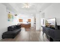 Bright living room with hardwood floors and an open-concept design, seamlessly flowing into the kitchen at 2234 N Normandy Blvd, Deltona, FL 32725
