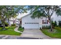 Charming home with a well-maintained yard, white siding, attached garage and an inviting front porch at 232 River Village Dr, Debary, FL 32713