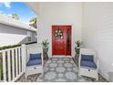 Welcoming front porch with seating, decorative rug, vibrant door, and pleasant curb appeal at 232 River Village Dr, Debary, FL 32713