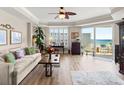 Inviting living room with stylish furnishings, hardwood floors, and a glimpse of the ocean view through the balcony doors at 2403 S Atlantic Ave # 410, Daytona Beach, FL 32118