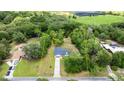 Aerial view of property showing boundaries surrounded by lush greenery and a beautiful treeline at 2455 Whooping Crane Dr, De Leon Springs, FL 32130