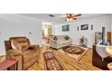 Cozy living room featuring hardwood floors, comfortable seating, and natural light at 2468 Kimberly Dr, Deltona, FL 32738