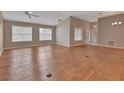 Open concept living room featuring hardwood floors, neutral walls and plenty of natural light at 2480 S Glen Eagles Dr, Deland, FL 32724