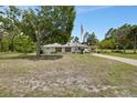 Inviting single-story home with a well-kept lawn and a flag pole in the front yard at 25305 Mardon Cir, Paisley, FL 32767