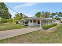 Beautiful home featuring manicured landscaping, a carport, and a screened porch, set on a spacious lot at 25305 Mardon Cir, Paisley, FL 32767