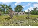 Quaint single-Gathering home with a spacious lawn and flowering bushes at 28045 Poinsettia Ave, Paisley, FL 32767