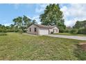 View of the side of the home with a two-car garage and driveway at 28045 Poinsettia Ave, Paisley, FL 32767