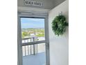 Condo doorway with a decorative wreath, and scenic view outside the storm door at 2860 Ocean Shore Blvd # 5020, Ormond Beach, FL 32176