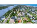 High-angle view of the home surrounded by water and other properties with pools at 3 Sea Dance Ter, Ormond Beach, FL 32176