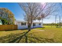 Single-story home featuring a well-maintained lawn, mature trees, and a fenced backyard at 302 Lafayette St, Port Orange, FL 32127