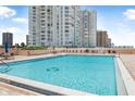 Relaxing community pool with comfortable lounge seating and ocean views at 3051 S Atlantic Ave # 1003, Daytona Beach, FL 32118