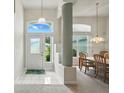 Bright foyer featuring tile flooring, high ceilings, and elegant lighting fixtures at 3776 Sweet Grove Ct, Port Orange, FL 32129