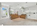 Open-concept living area with neutral carpet, high ceilings, and abundant natural light at 3776 Sweet Grove Ct, Port Orange, FL 32129