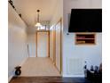 Hallway with neutral paint, tile floor, a pendant light, and coat closet at 4204 Rocky Ridge Pl, Sanford, FL 32773