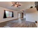 Bright living room featuring hardwood floors, vaulted ceilings, and access to the kitchen at 4204 Rocky Ridge Pl, Sanford, FL 32773