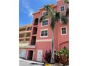Exterior view of condos with a palm tree, stairs, and a view of the building's architecture at 424 Luna Bella Ln # 330, New Smyrna Beach, FL 32168