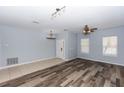 Open-concept living room showcasing wood floors and ample natural light at 452 Casa Marina Pl, Sanford, FL 32771