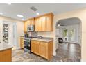 Bright kitchen featuring stainless steel appliances, and light wood cabinets, open to living area at 4638 Saxon Dr, New Smyrna Beach, FL 32169