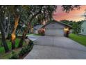 This home has a spacious garage with beautiful landscaped lawn and mature trees at 4791 S Peninsula Dr, Ponce Inlet, FL 32127