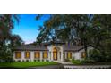 This well-maintained single-story home has a fountain, a tile roof, and a well-manicured lawn at 4885 State Road 11, De Leon Springs, FL 32130
