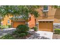 Inviting two-story townhome with brick-paved driveway, manicured landscaping, and an attractive front exterior at 5060 Cypress Branch Pt, Oviedo, FL 32765