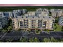Beautiful condo building exterior showcasing ample parking and well-maintained landscaping at 5300 S Atlantic Ave # 12-401, New Smyrna Beach, FL 32169