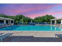 Inviting pool area with comfortable lounge chairs and lush greenery, ideal for leisure at 5300 S Atlantic Ave # 12-401, New Smyrna Beach, FL 32169