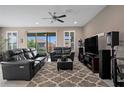 Comfortable living area featuring plush seating, a sliding glass door, and entertainment center at 5648 Nw 40Th Loop, Ocala, FL 34482