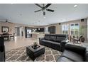 Open-concept living room with a spacious layout, ceiling fan, and access to dining and kitchen at 5648 Nw 40Th Loop, Ocala, FL 34482