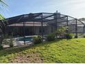 View of the covered and screened in-ground pool at 6211 Oak River Ter, Port Orange, FL 32127