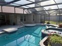 Beautiful in-ground pool and hot tub area surrounded by a screened enclosure at 6211 Oak River Ter, Port Orange, FL 32127