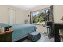 Cozy bedroom featuring ample natural light and a tranquil view of the surrounding greenery at 626 Cannon St, Daytona Beach, FL 32114