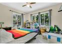 A spacious bedroom with two windows offering abundant natural light and a view of the surrounding greenery at 626 Cannon St, Daytona Beach, FL 32114
