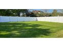 Spacious backyard featuring a lush green lawn and a privacy fence at 1693 Arash Cir, Port Orange, FL 32128