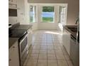 Well-lit eat-in kitchen with tiled floors and ample cabinet space at 1693 Arash Cir, Port Orange, FL 32128