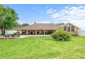 Expansive backyard with a brick patio, covered porch, and outdoor seating area at 202 Yorkville Pl, Debary, FL 32713