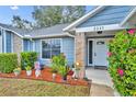 Inviting front porch adorned with colorful flowers and charming decorations, creating a warm and welcoming entrance at 2237 Clearwater Dr, Deltona, FL 32738