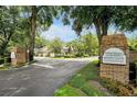 Welcome to Wekiva Hunt Club Condominiums, featuring a well-manicured entrance, lush trees, and picturesque surroundings at 3988 Radley Ct, Longwood, FL 32779