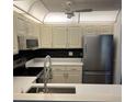 Well-equipped kitchen with stainless steel appliances and sleek black backsplash at 79 Cypress Pond Rd # 79, Port Orange, FL 32128