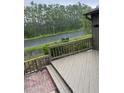 Cozy porch featuring a wooden railing and a view of the green landscape at 79 Cypress Pond Rd # 79, Port Orange, FL 32128