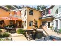 Outdoor patio with a fountain, seating, and a view of the colorful architecture at 4920 Sw 78Th Ave, Bushnell, FL 33513