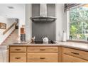 Modern kitchen with a stainless steel range hood and views of the stairwell and backyard at 4920 Sw 78Th Ave, Bushnell, FL 33513